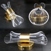 stylish golden hourglass wall sconce on interior wall